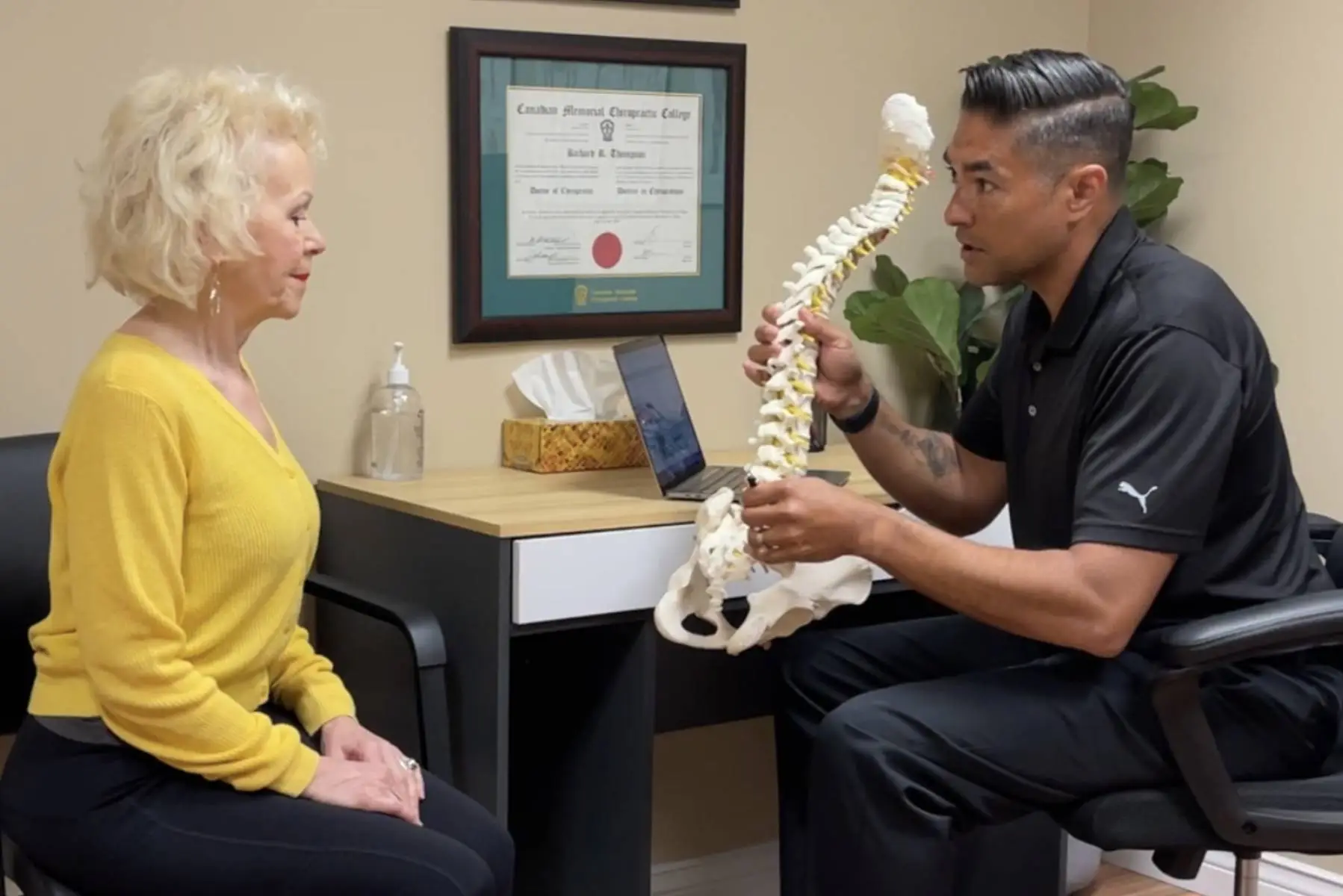 a woman is sitting in a chair with a doctor